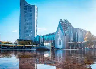 blue and white concrete building near body of water during daytime